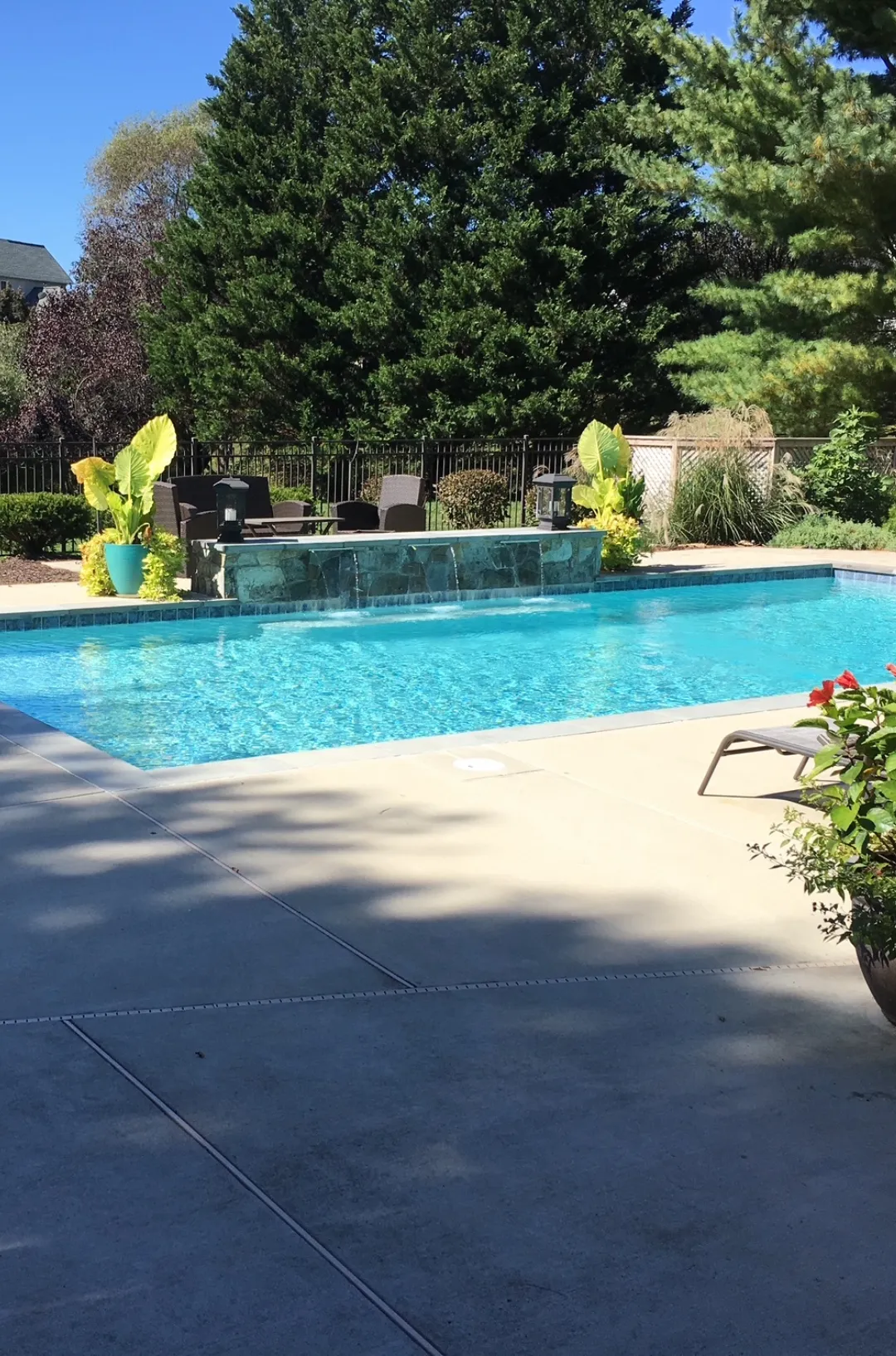Luxury swimming pool with raised spa and waterfall spillway feature in Northern Virginia