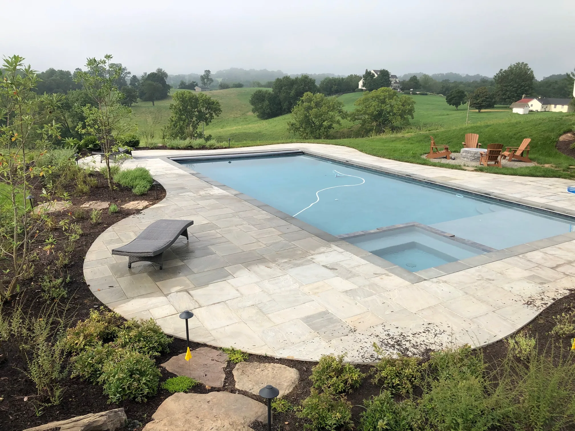 Large fully renovated residential swimming pool with new plaster finish, tile, coping, and upgraded equipment in Northern Virginia